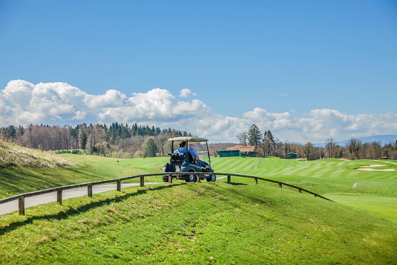 golf-truck-riding-through-the-path-in-the-golf-cou-2025-02-02-13-19-04-utc